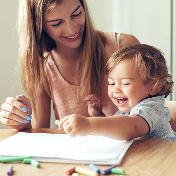 A woman and a child are playing at the table