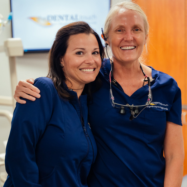 Two women dentists are happily smiling