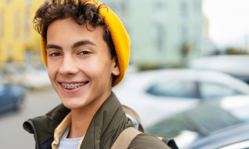 Smiling patient filing happy with braces