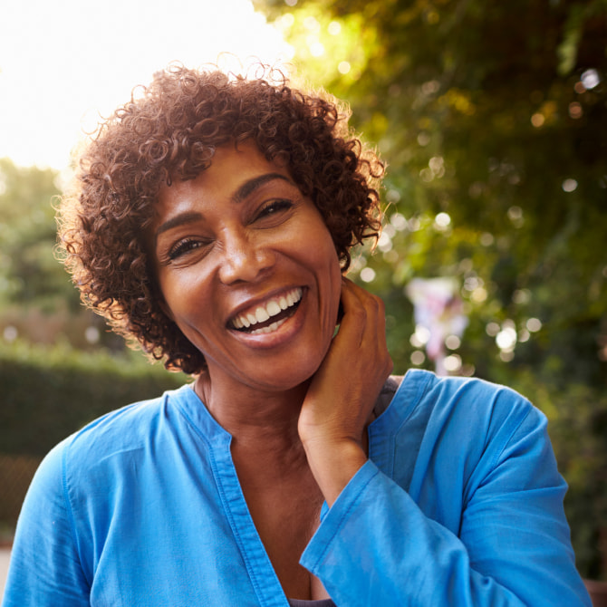 A photo of happy smiling woman with curly hair