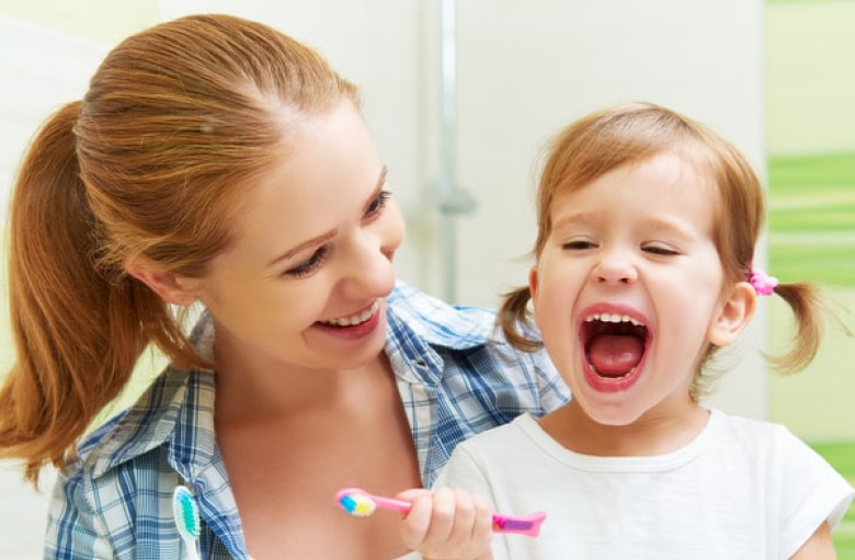 Photo of mother and her daughter wearing white shirt