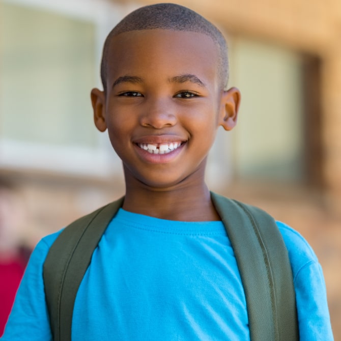 A photo of happy smiling boy with short hair cut