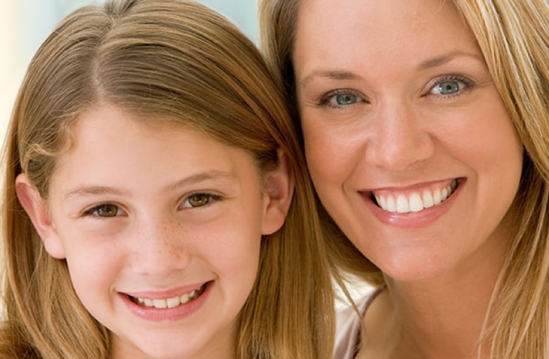 Girl and her mother smiling together