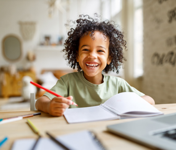 A photo of smiling kid with curly hair