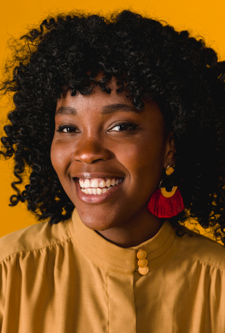 A photo of smiling woman with curly hair