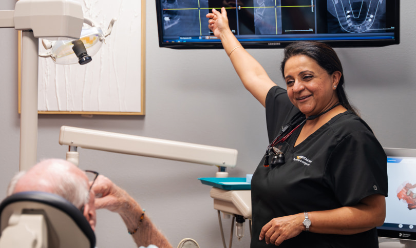 Doctor show patient his tooth shots on the screen