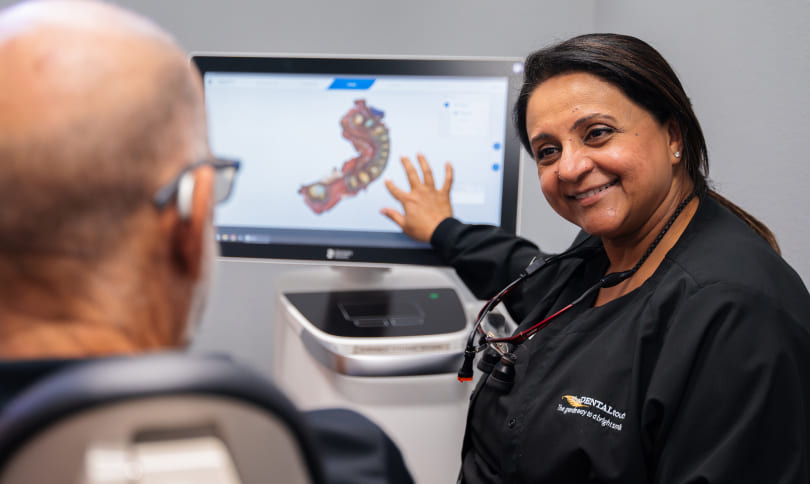 Doctor showing to patient how jaws will be looking