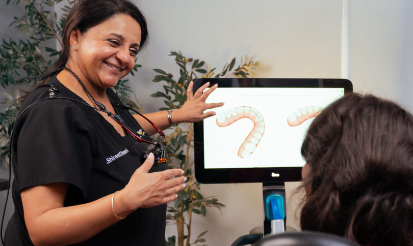 Doctor showing patient how laser dentistry works