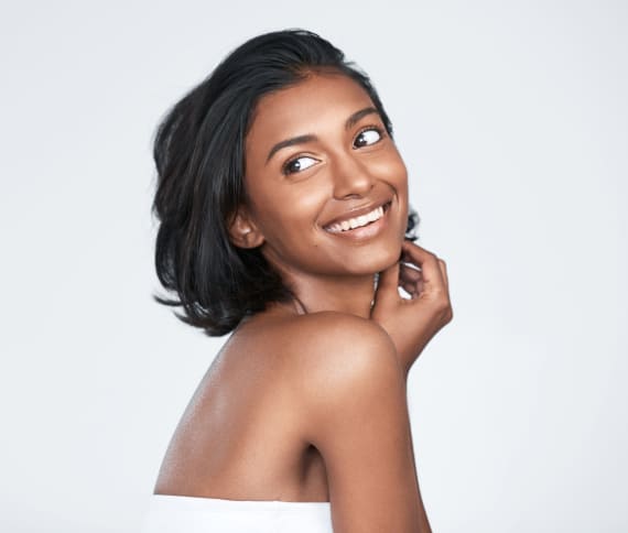 Girl happily smiling while wearing white dress