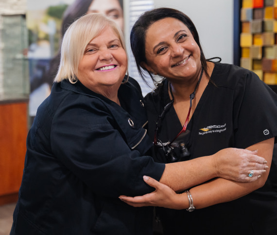 Happy patient smiling while hugging a doctor
