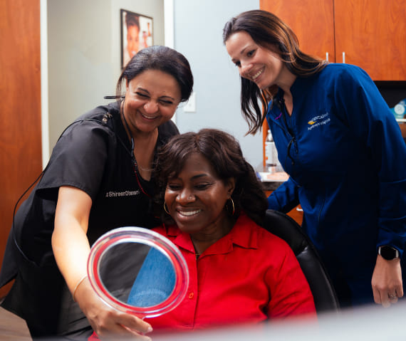 Our patient happily smiling in the mirror 