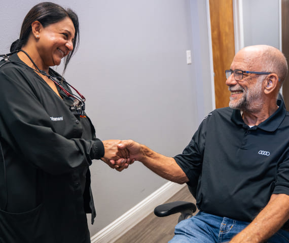 Our patient happily smiling while shaking hand with doctor