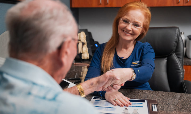 Patient and team member shaking hands