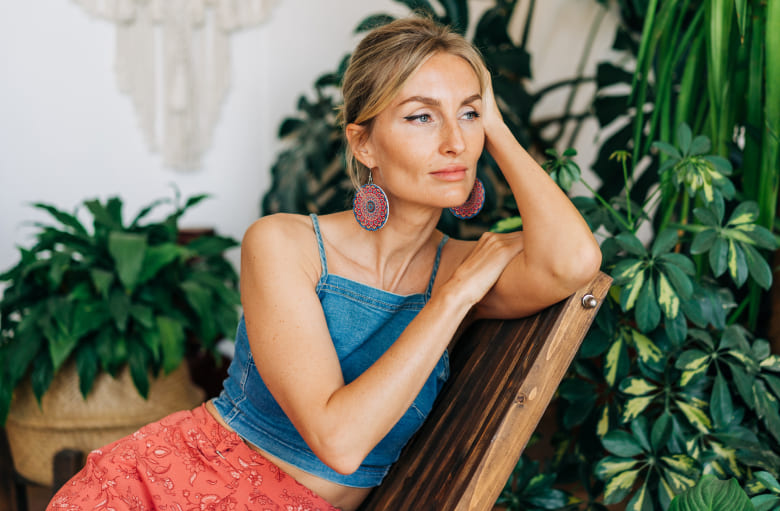 Woman is smiling while sitting on the chair
