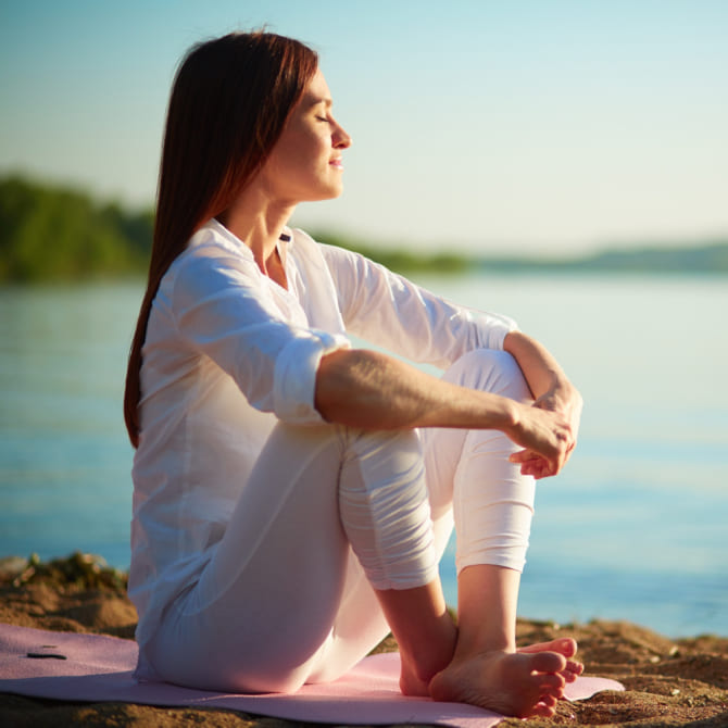 Woman smiling while meditating