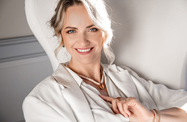 Woman smiling while sitting on sofa
