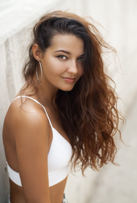 Woman with curly hair is smiling