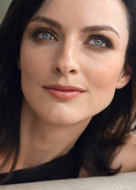 Woman with dark hair is smiling