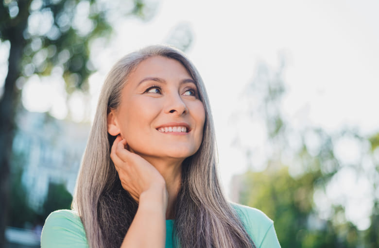 Woman with grey hair is smiling