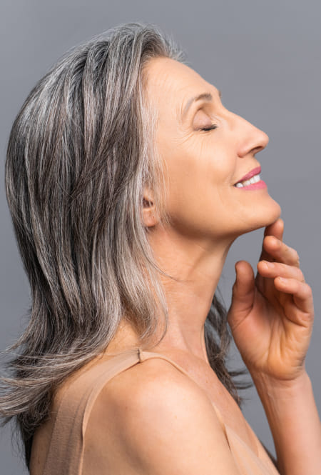 Woman with grey hair is smiling