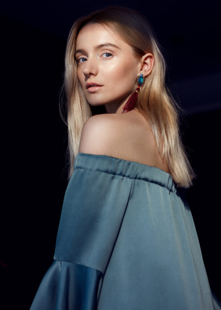 Woman with light hair look seriously